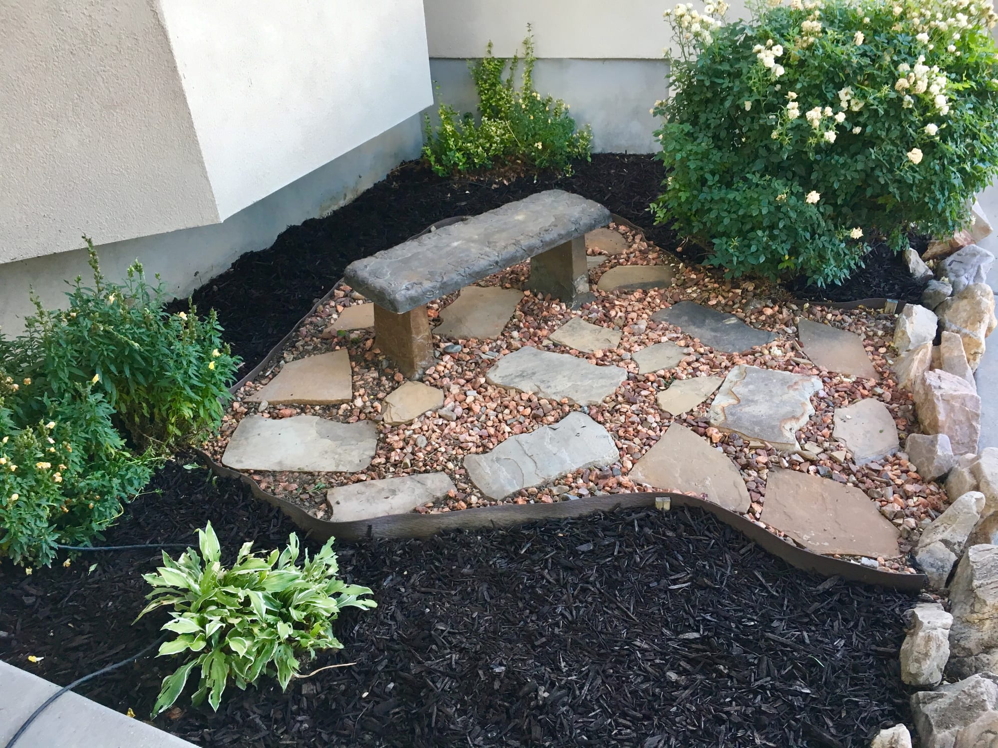 mulch landscape stones gravel pebbles flowerbed landscaped courtyard snapdragon bench orange trained stepping calculator