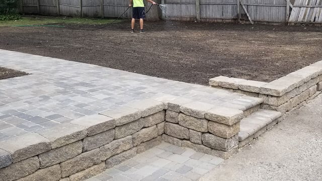 Retaining walls and steps on a home in Minneapolis creates a flat yard and removes the unwanted slope in their backyard.