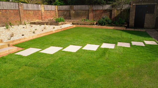 Landscaping Ideas for Your Backyard - New sod installed around a stepping stone pathway in a garden or back yard
