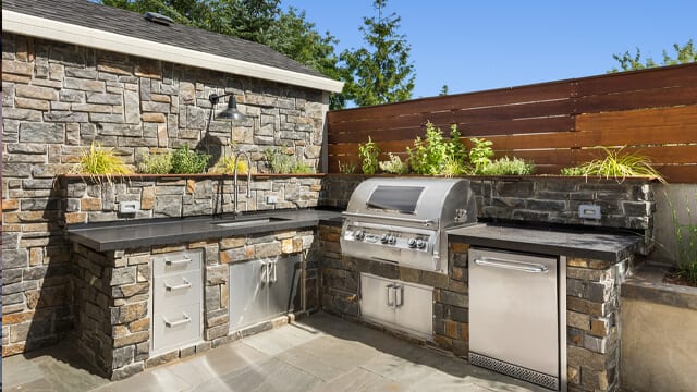 Adding a built-in grill and kitchen area can turn your backyard into an extension of your home.