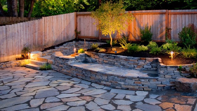 For smaller backyards, a seating area and stone patio make this area more useable for entertaining.