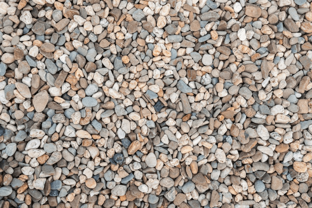 Using natural materials like pebbles or stone can be cost effective and help prevent weeds and rodents.